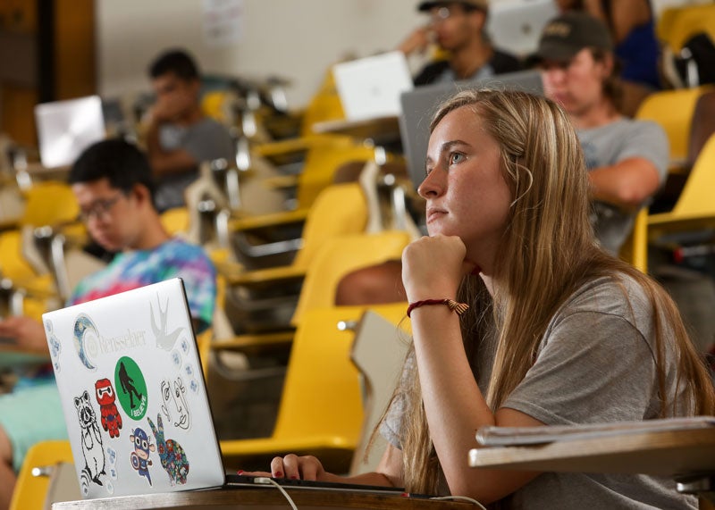 Student sits in front of computer during a lecture
